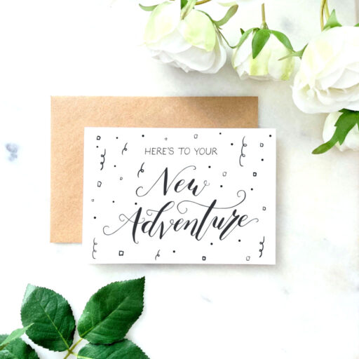 HERES-TO-YOUR-NEW-ADVENTURE-FRONT-FLATLAY-CARD.jpg